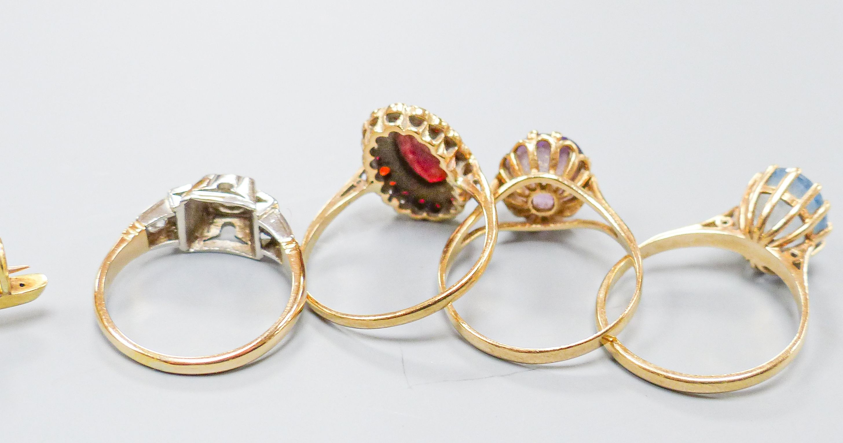 Three 18ct gold and gem set rings including two five stone half hoop(one stone missing) and a sapphire and diamond three stone, gross weight 7.3 grams, four 9ct and gem set rings and a 9ct pendant, gross 11.8 grams, a 15